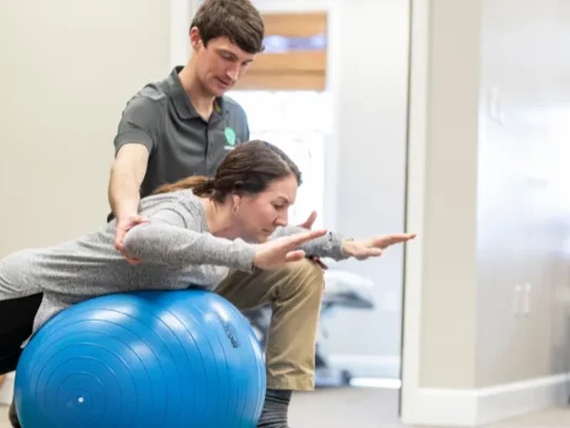 Doctor of Physical Therapy using an IASTM tool on a patient's shoulder