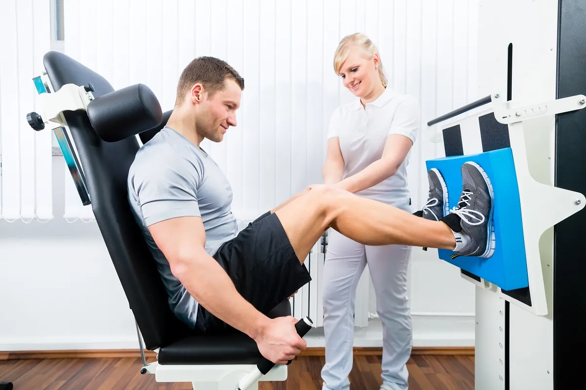 Physiotherapist exercising patient in sport therapy